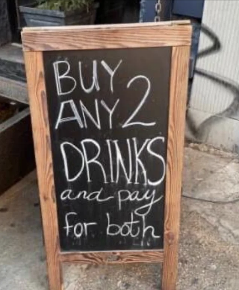 Signboard offering a deal: "Buy any 2 drinks and pay for both."