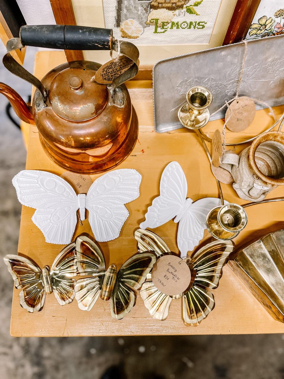 A teapot and some brassy butterflies.