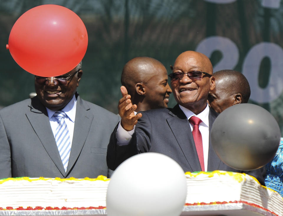 South Africa president Jacob Zuma, right, releases balloons during commemorations to mark 20 years of democracy at the government's Union Building in Pretoria, South Africa, Sunday, April 27, 2014. South Africans are celebrating 20 years of democracy with songs and speeches, but some note that economic inequality and other problems have undermined their nation's promise since the first all-race elections on April 27, 1994 ended white rule. (AP Photo)