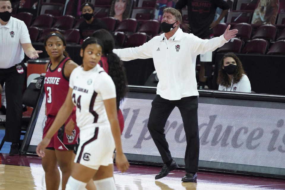 North Carolina State coach Wes Moore talks to an official during the first half of the team's NCAA college basketball game against South Carolina on Thursday, Dec. 3, 2020, in Columbia, S.C. (AP Photo/Sean Rayford)