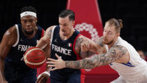 France's Thomas Heurtel, center, steals the ball from Czech Republic's Patrik Auda, right, as Guerschon Yabusele, left, looks on during a men's basketball preliminary round game at the 2020 Summer Olympics in Saitama, Japan, Wednesday, July 28, 2021. (AP Photo/Charlie Neibergall)