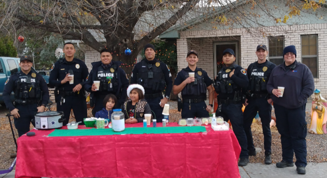 Suzette Martinez, 8, in Santa hat, gives first responders free hot chocolate and cookies on Saturday, Dec. 18, 2021.