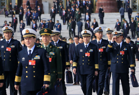 Military delegates leave the Great Hall of the People after a meeting ahead of National People's Congress (NPC), China's annual session of parliament, in Beijing, China March 4, 2019. REUTERS/Aly Song