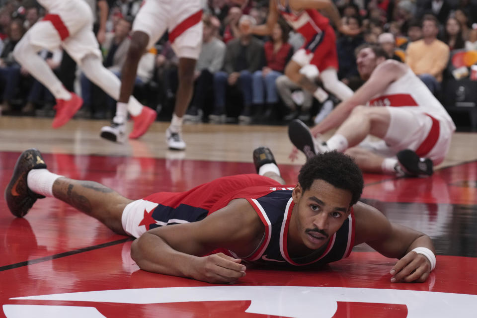 Washington Wizards' Jordan Poole, foreground, reacts during preseason NBA basketball game action against the Toronto Raptors in Toronto, Friday Oct. 20, 2023. (Chris Young/The Canadian Press via AP)