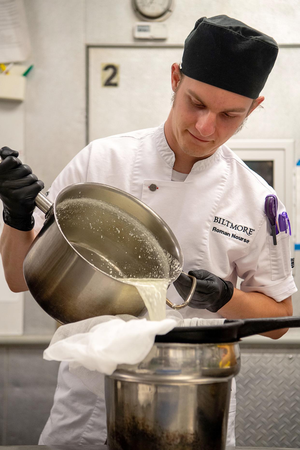 Banquet Demi Chef Roman Nourse strains the contents of a pot as he makes burrata in the kitchen at The Inn on Biltmore Estate, July 9, 2024.