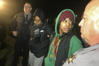 Tolani King, second from left, and Misty Cross are led away by Alameda County Sheriff's deputies after being removed from a house they were illegally occupying Tuesday, Jan. 14, 2020, in Oakland, Calif. Homeless women ordered by a judge last week to leave a vacant house they occupied illegally in Oakland for two months have been evicted by sheriff's deputies. They removed two women and a male supporter Tuesday from the home before dawn in a case highlighting California's severe housing shortage and growing homeless population. (Marisa Kendall/ Bay Area News Group via AP)