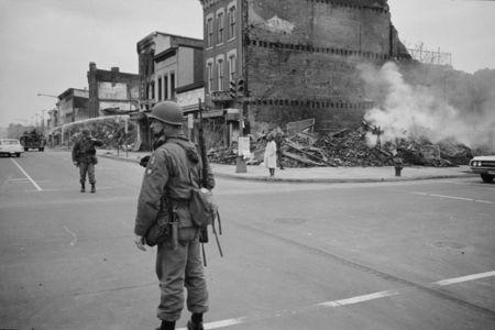 April 8, 1968: A soldier stands guard at 7th and N Street, N.W., Washington, D.C., with the ruins of buildings destroyed during the riots that followed the assassination of Martin Luther King, Jr., in the background. REUTERS/Library of Congress/Handout via Reuters