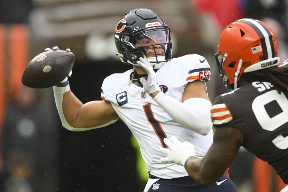 Chicago Bears quarterback Justin Fields (1) sets back to pass in the first half of an NFL football game against the in Cleveland, Sunday, Dec. 17, 2023. (AP Photo/David Richard)