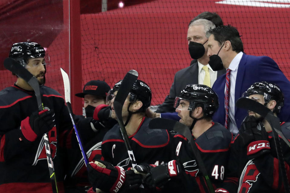 Carolina Hurricanes' head coach Rod Brind'Amour, right, directs the team during the first period of an NHL hockey game against the Detroit Red Wings in Raleigh, N.C., on Thursday, March 4, 2021. (AP Photo/Chris Seward)