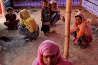 Rohingya refugees pass the time at the kitchen of the camp for widows and orphans inside the Balukhali camp near Cox's Bazar, Bangladesh, December 5, 2017. More than 230 women and children live at a so-called widows camp built by fellow refugees with the help of donor funds for Rohingya widows and orphans to offer them better protection and shelter. REUTERS/Damir Sagolj