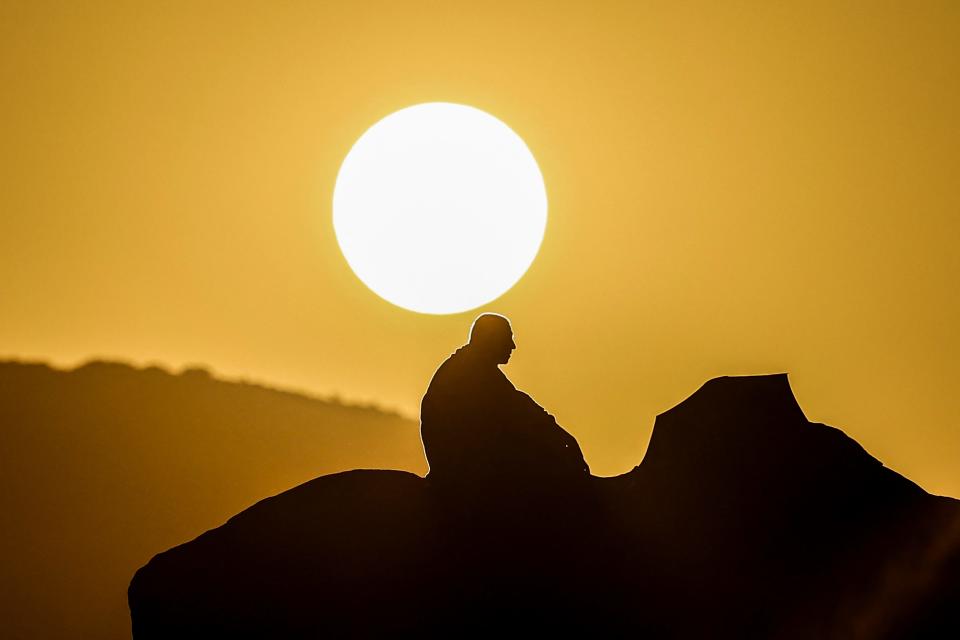 A Muslim pilgrim prays at dawn on Mount Arafat, also known as Jabal al-Rahma or Mount of Mercy, during the annual hajj pilgrimage on June 15, 2024.