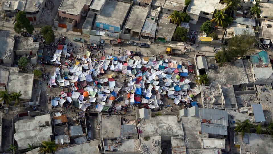 A group of tents stands amidst the rubble after an earthquake in Port-au-Prince, Haiti, on January 12, 2010, in this United Nations handout photo. - Ho New/Reuters