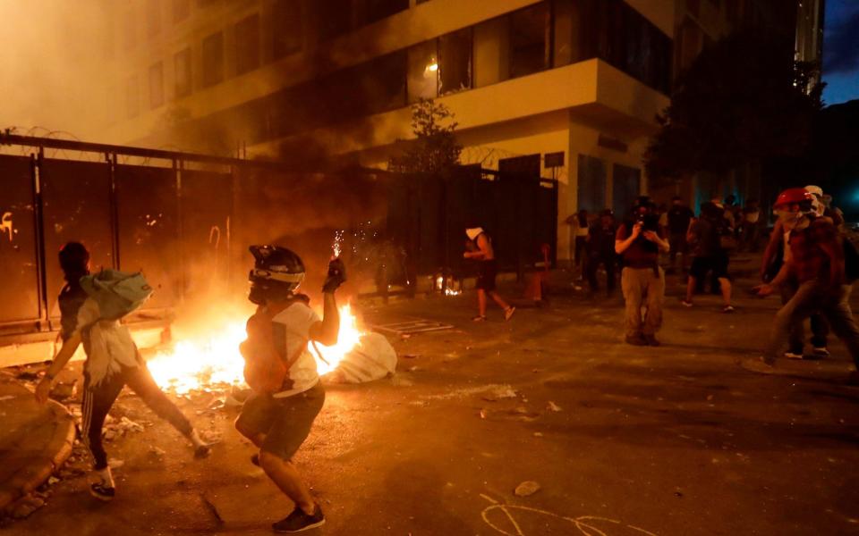 Lebanese protesters, enraged by a deadly explosion blamed on government negligence, clash with security forces for the second evening near an access street to the parliament in central Beirut - AFP