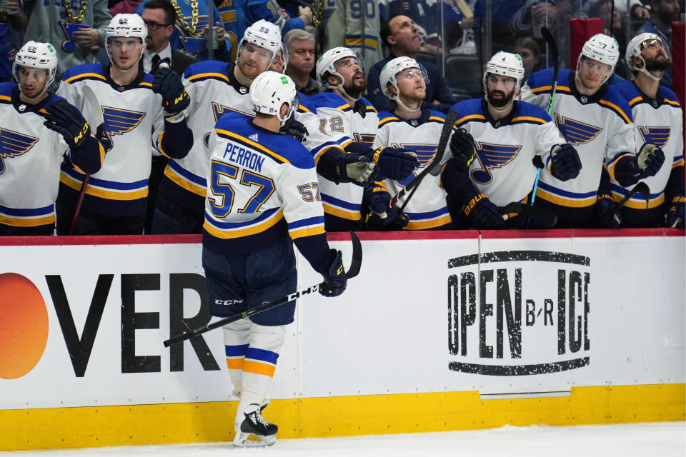 St. Louis Blues left wing David Perron (57) is congratulated for his goal against the Colorado Avalanche during the second period in Game 2 of an NHL hockey Stanley Cup second-round playoff series Thursday, May 19, 2022, in Denver. (AP Photo/Jack Dempsey)