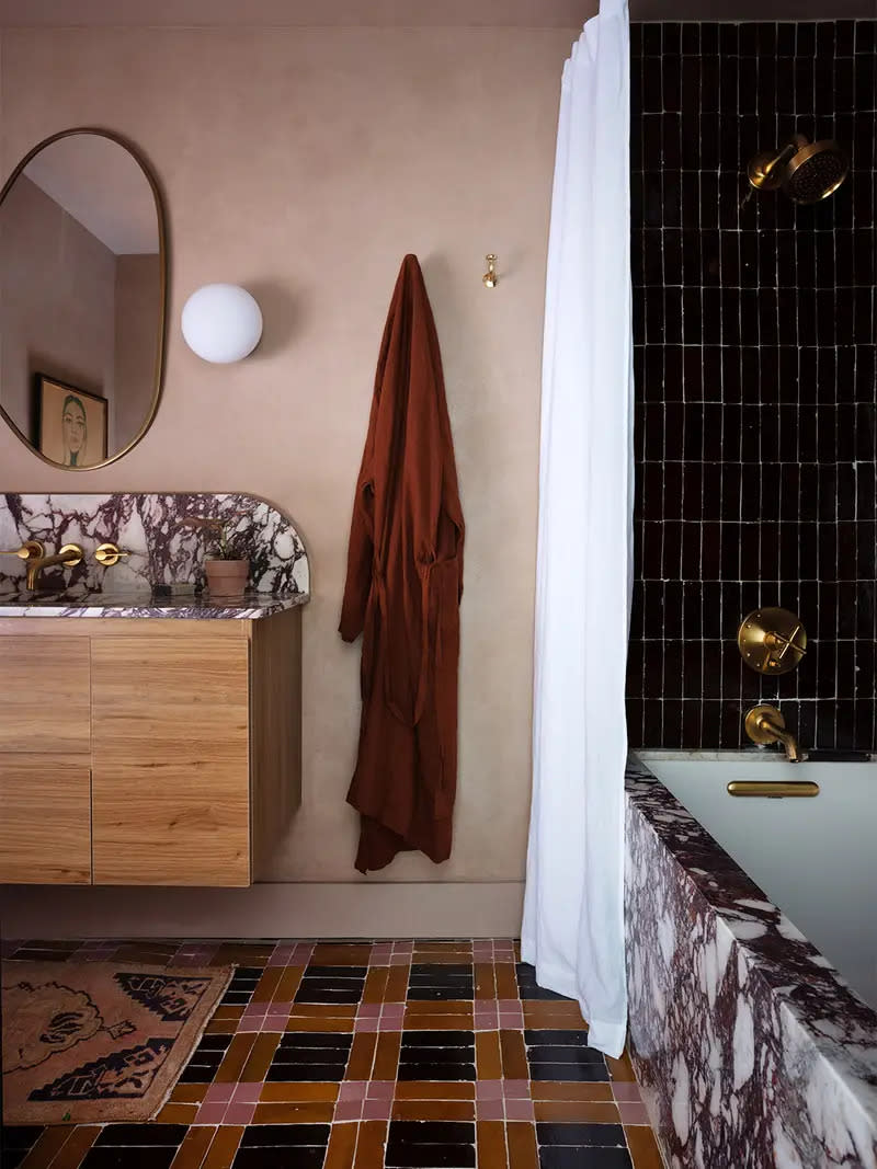 Bathroom with black, mustard- and pink plaid tile.