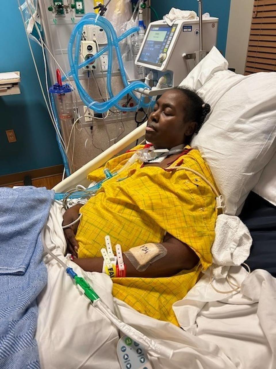 Lacette Green, a counselor at Rosemont Middle School in Fort Worth, is pictured in her hospital bed with a tracheostomy tube during her five-week coma. She woke up the second week of January 2024 and is recovering.