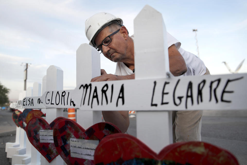 FILE - In this Aug. 5, 2019, file photo Greg Zanis of Aurora, Ill., prepares crosses to place at a makeshift memorial for victims of a mass shooting at a shopping complex in El Paso, Texas. Now on hospice care, Zanis, continues to struggle against the terminal bladder cancer he was diagnosed with in March, was treated to a motorcade of well-wishers in his driveway for over two hours, Friday, May 1, 2020, in Aurora. (AP Photo/John Locher, File)