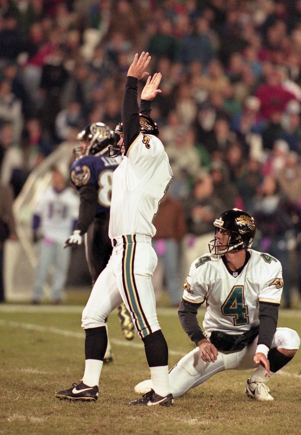 Jacksonville Jaguars kicker Mike Hollis (1) throws his arms up to signal that the kick was good just after making a 34-yard game-winning field goal, winning the game in overtime against the Baltimore Ravens on November 24, 1996. This was the Jaguars' very first overtime victory.  [Dennis Hamilton Jr./Florida Times-Union]