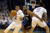 May 6, 2016; Oklahoma City, OK, USA; San Antonio Spurs forward Kawhi Leonard (2) fights past a screen set by Oklahoma City Thunder center Steven Adams (12) while pursuing Oklahoma City Thunder guard Russell Westbrook (0) during the first quarter in game three of the second round of the NBA Playoffs at Chesapeake Energy Arena. Mandatory Credit: Mark D. Smith-USA TODAY Sports