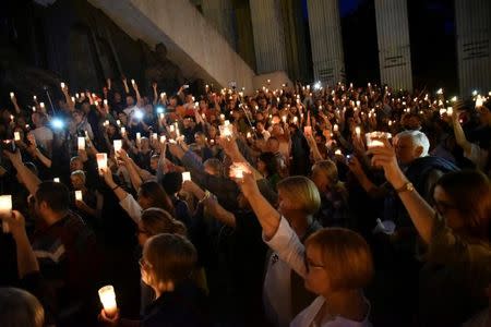 Protesters hold candles during a candlelight rally to protest against judicial reforms in front of the Supreme Court in Warsaw, Poland, July 16, 2017. Agencja Gazeta/Franciszek Mazur via REUTERS