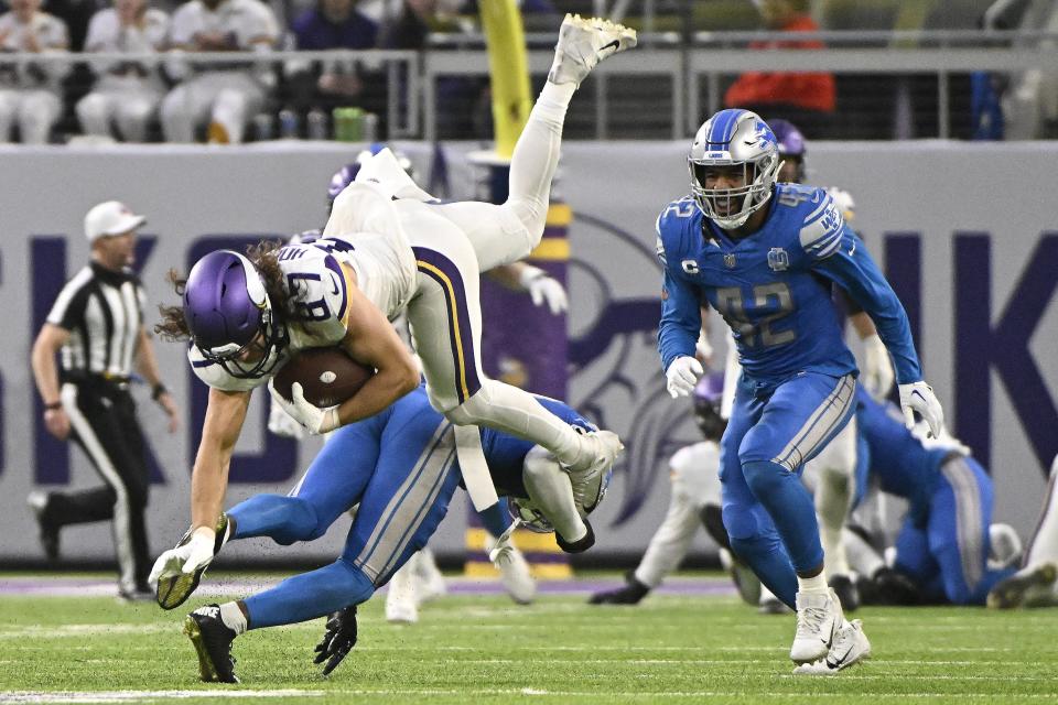 T.J. Hockenson of the Minnesota Vikings is tackled by Kerby Joseph of the Detroit Lions during the third quarter at U.S. Bank Stadium in Minneapolis on Sunday, Dec. 24, 2023.