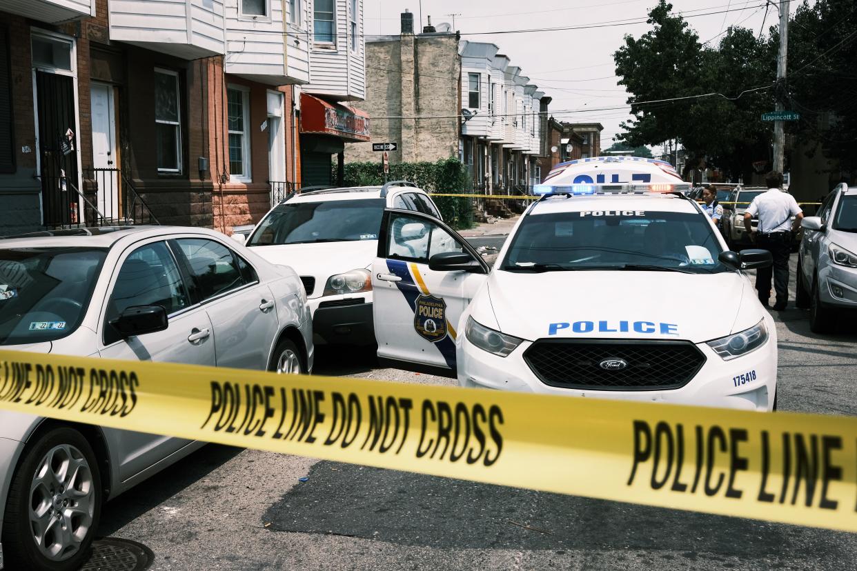 Police tape in front of cop car