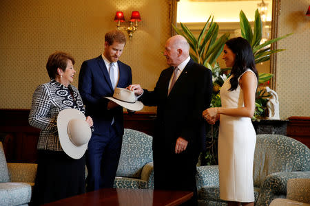 Britain's Prince Harry and wife Meghan, Duchess of Sussex look at bush hats with Australia's Governor General Peter Cosgrove and his wife Lynne Cosgrove at Admiralty House during their visit in Sydney, Australia October 16, 2018. REUTERS/Phil Noble/Pool