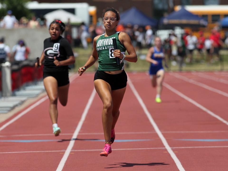 Northridge's Stephanie Gilmore carries the baton for the final leg of the Division II girls 800 relay during the state championships on Friday.