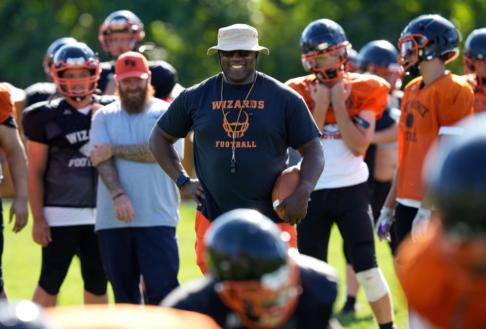 West Warwick head coach Wes Pennington shares a laugh with his players during practice last week. Despite the smiles here, Pennington has instituted a hard-nosed kind of attitude on the Wizards.