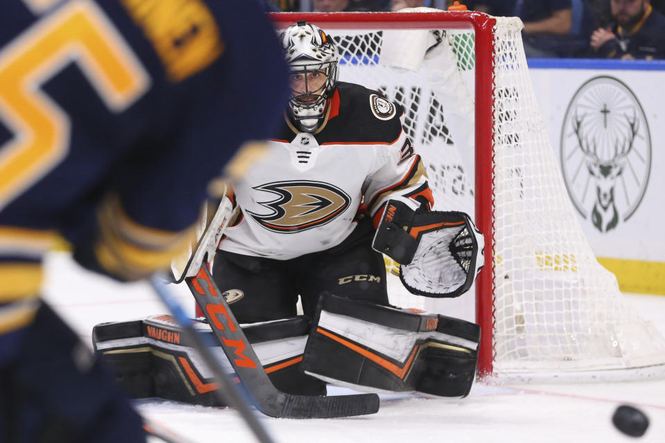 Anaheim Ducks goalie Ryan Miller (30) keeps his eyes on the puck during the third period of an NHL hockey game against the Buffalo Sabres, Sunday, Feb. 9, 2020, in Buffalo, N.Y. (AP Photo/Jeffrey T. Barnes)