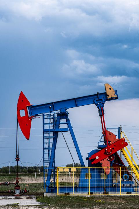 Oil drilling derrick pumps oil from ground. Petroleum industry, crude oil extraction. Production of fuel from natural resources. Oil crisis. Vertical