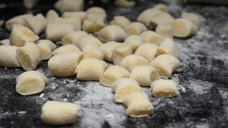 homemade gnocchi on black surface