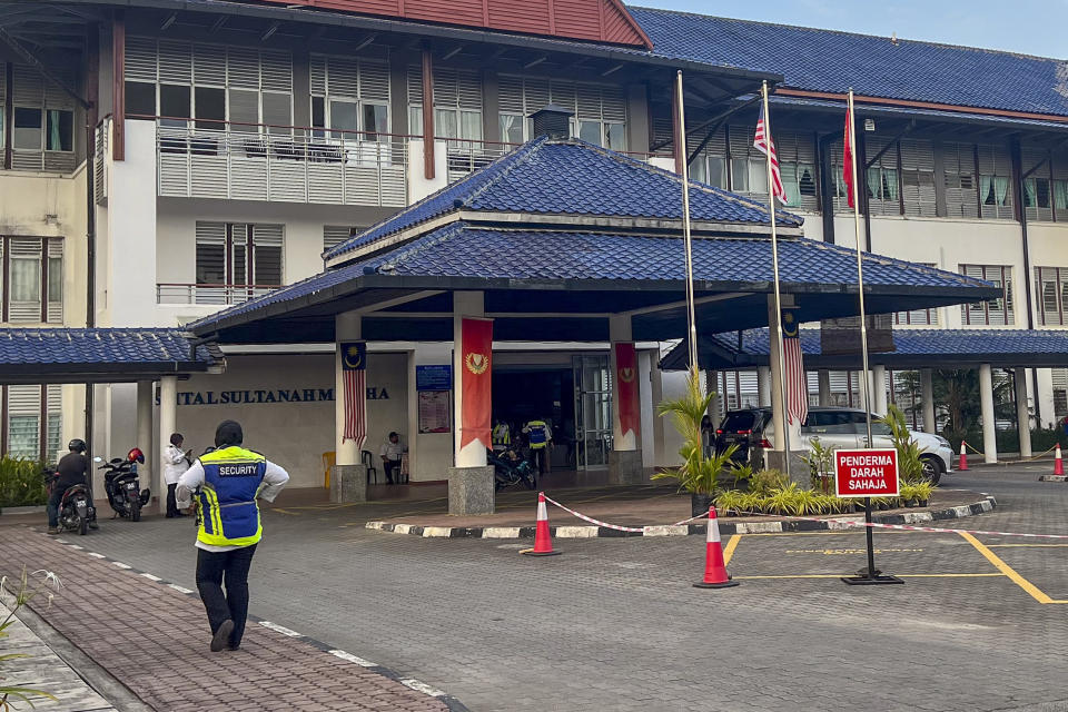 A security officer walks outside the Sultanah Maliha Hospital, where King Harald V of Norway is believed to be admitted with an infection, on the Malaysian resort island of Langkawi, Malaysia, Wednesday, Feb. 28, 2024. Malaysian national news agency Bernama cited unidentified sources as confirming that Europe's oldest monarch was warded at the hospital’s Royal Suite. (AP Photo/Vincent Thian)
