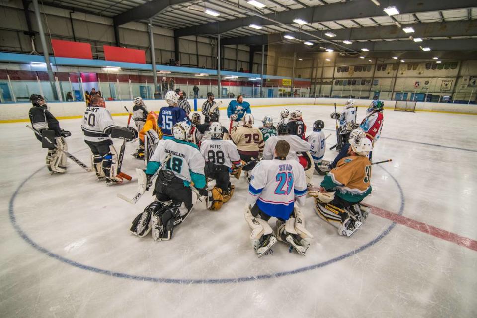 Participants gather at center ice during the “Oops! All Goalies” hockey game at the Bellingham Sportsplex on Saturday, February 17.