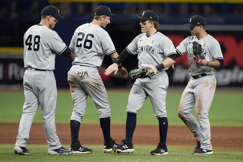 New York Yankees, from left, first baseman Anthony Rizzo, third baseman DJ LeMahieu, center fielder Harrison Bader and center fielder Isiah Kiner-Falefa celebrate after the team defeated the Tampa Bay Rays during a baseball game Saturday, May 6, 2023, in St. Petersburg, Fla. (AP Photo/Chris O'Meara)