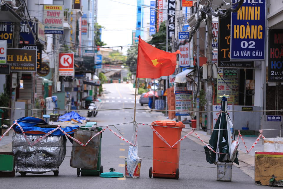 A street is blocked with carts and trash cans during a virus lockdown in Vung Tau, Vietnam on Sept. 13, 2021. More than a half of Vietnam is under a lockdown order to contain its worst virus outbreak yet. (AP Photo/Hau Dinh)