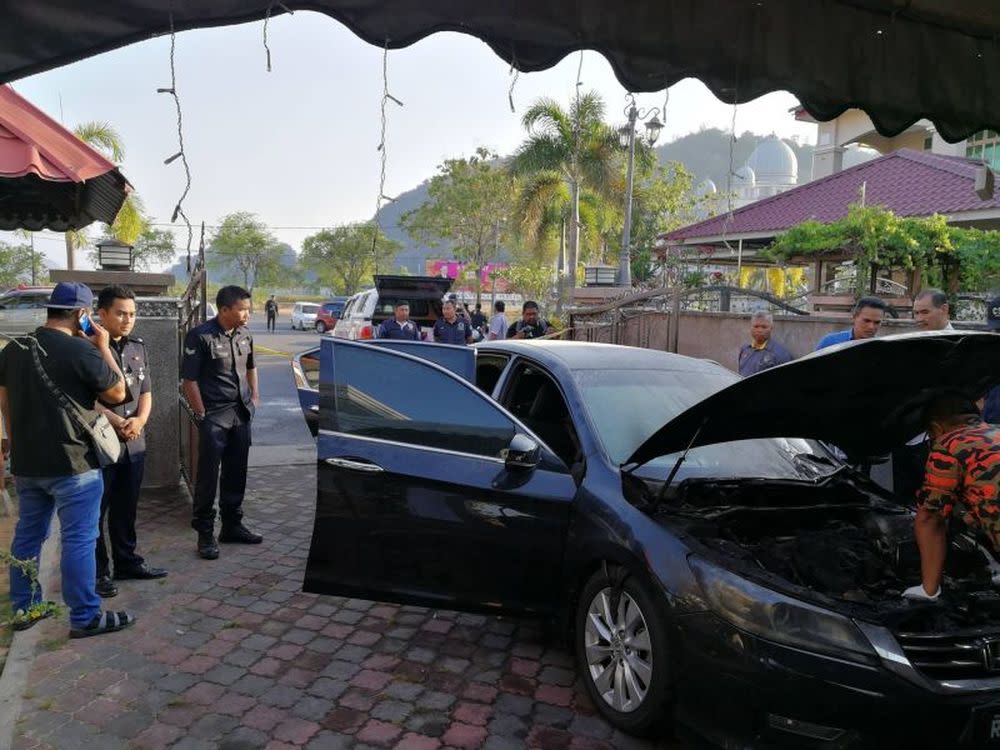 In the 5.45am incident on March 22, Mohd Asri's black Honda Accord car was burnt in the engine and left front tyre while the front and back windscreens were smashed. — Picture via Facebook/Dr Maza.com