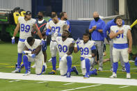 Members of the Los Angeles Rams stand and kneel during the national anthem before an NFL football game against the Dallas Cowboys Sunday, Sept. 13, 2020, in Inglewood, Calif. (AP Photo/Ashley Landis)