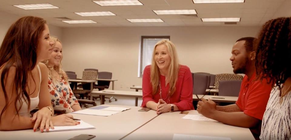 Flagler College-Tallahassee's education coordinator Andrea Carlile (middle) sits with a few students.