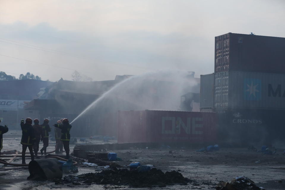 Firefighters work to contain a fire that broke out at the BM Inland Container Depot, a Dutch-Bangladesh joint venture, in Chittagong, 216 kilometers (134 miles) southeast of capital, Dhaka, Bangladesh, early Sunday, June 5, 2022. Several people were killed and more than 100 others were injured in the fire the cause of which could not be immediately determined. (AP Photo)