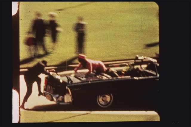 ZAPRUDER FILM 1967 (Renewed 1995) The Sixth Floor Museum at Dealey Plaza Jackie Kennedy climbs out of the back seat after President John F. Kennedy was fatally shot beside her