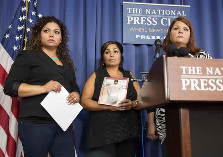 Rosie Cortinas (L), Monica Coronado (2nd L) and Laura Christian, who are family members of General Motors crash victims, speak after a news conference held by Kenneth Feinberg, a victims compensation lawyer hired by General Motors, in Washington June 30, 2014. REUTERS/Joshua Roberts