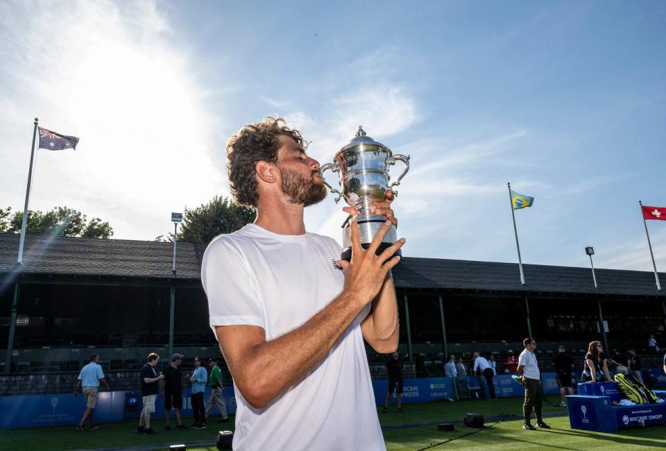 Maxime Cressy poses with the Van Alen Cup after beating Alexander Bublik for the singles title during the Infosys Hall of Fame Open at Center Court on Sunday in Newport.