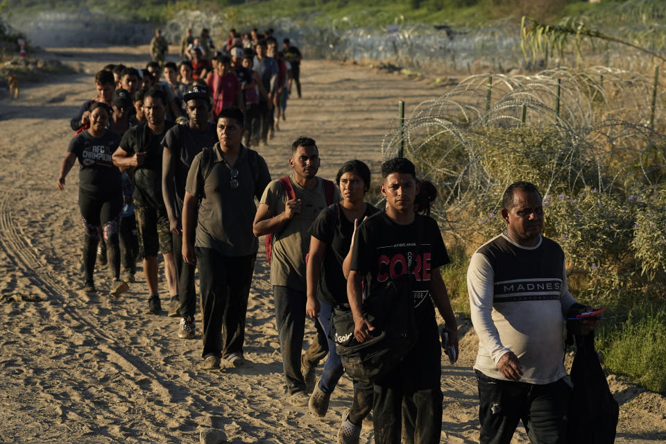 Migrants who crossed the Rio Grande and entered the U.S. from Mexico head to be processed by U.S. Customs and Border Protection, Saturday, Sept. 23, 2023, in Eagle Pass, Texas. (AP Photo/Eric Gay)