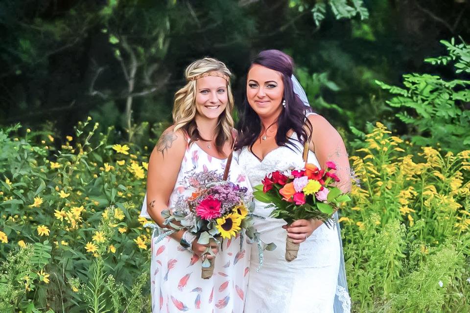 Bridesmaid and bride posing for photo