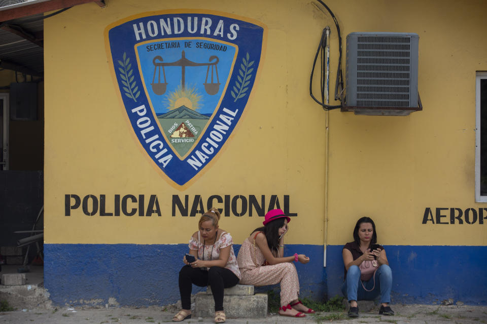 Family members wait outside the Ramon Villeda International Airport in La Lima, Honduras on Nov. 29, 2019, for the arrival of their relatives who were deported from the United States. Immigration apprehensions along the U.S.-Mexico border have plunged by more than 70 percent in the past six months, down sharply from at least 132,000 in May. (AP Photo/Moises Castillo)