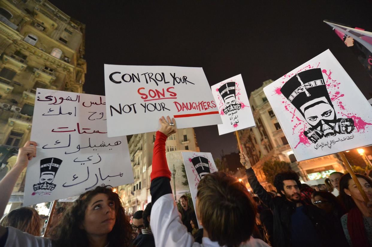Egyptian protesters hold placards and shout slogans during a demonstration in Cairo against sexual harassment and violence, in a February 12, 2013 file photo. / Credit: KHALED DESOUKI/AFP/Getty
