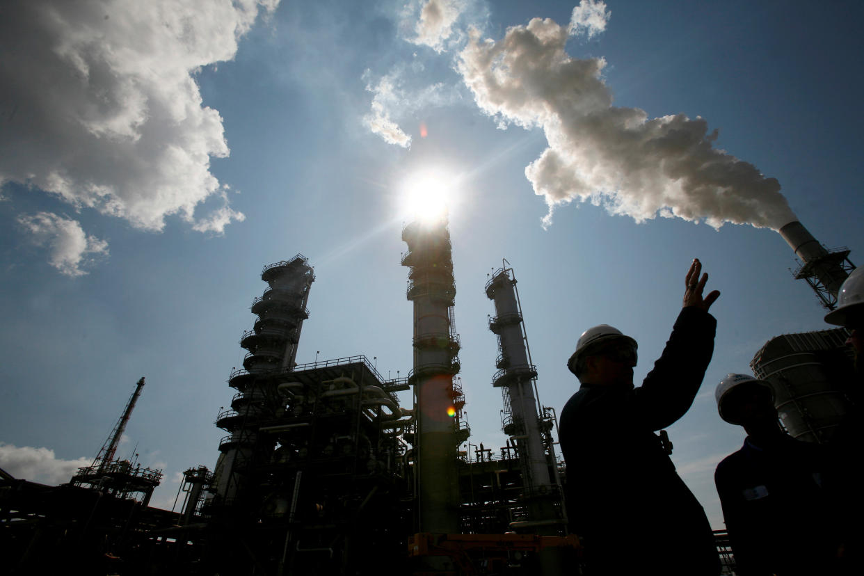 FILE PHOTO: James Prokupek (L), an engineering department process design manager for the Valero St. Charles Oil Refiner, is seen in silhouette during a tour of the refinery in Norco, Louisiana, August 15, 2008. REUTERS/Shannon Stapleton/File Photo