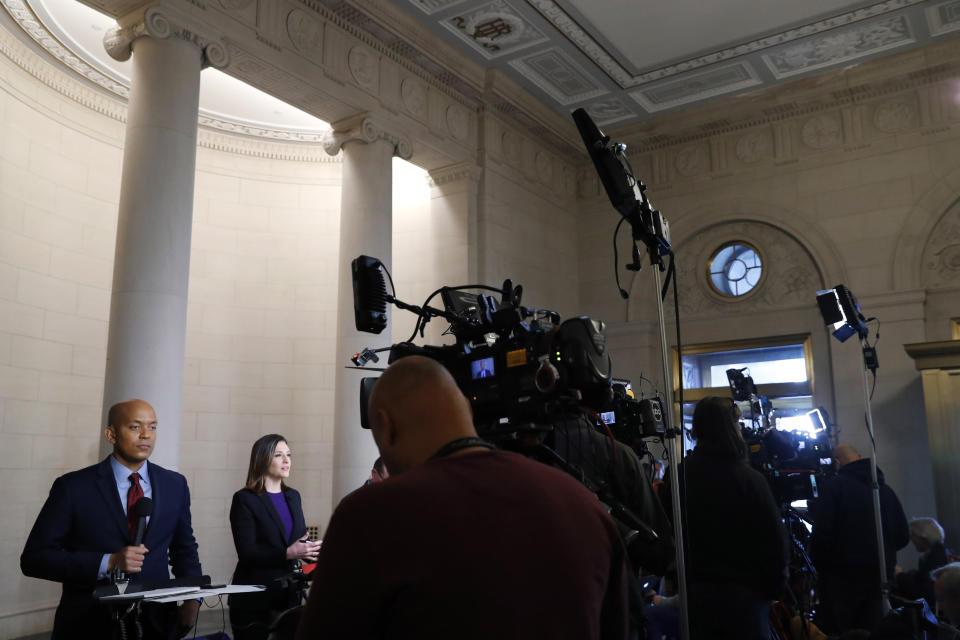 Television reporters report at the Longworth House Office Building where former U.S. Ambassador to Ukraine Marie Yovanovitch is testifying to the House Intelligence Committee, Friday, Nov. 15, 2019, on Capitol Hill in Washington, in the second public impeachment hearing of President Donald Trump's efforts to tie U.S. aid for Ukraine to investigations of his political opponents. (AP Photo/Jacquelyn Martin)