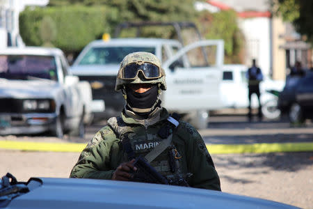 A Mexican marine keeps watch at a crime scene after a shooting with unknown assailants in Culiacan, Mexico, February 7, 2017. REUTERS/Jesus Bustamante